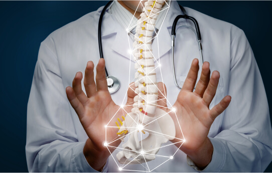 A doctor with their hands around a spine with pinpoints of light around it.